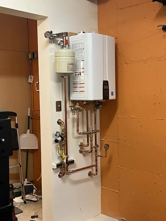 Plumbing technician inspecting water heater connections in Laguna Woods